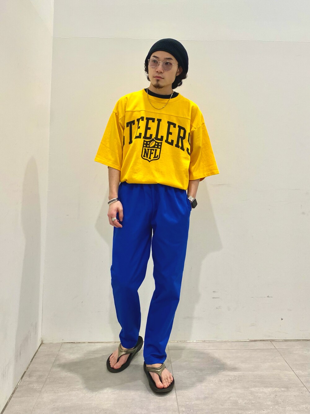 イエロー系のTシャツ/カットソー、ブルー系のチノパンツを着用したメンズの春コーディネートの1枚目の写真