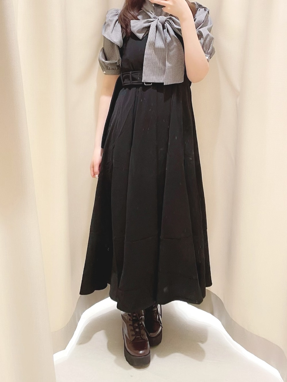 ブラウン系のブーツ、ブラック系のワンピース、ホワイト系のシャツ/ブラウスを着用したレディースの春コーディネートの1枚目の写真