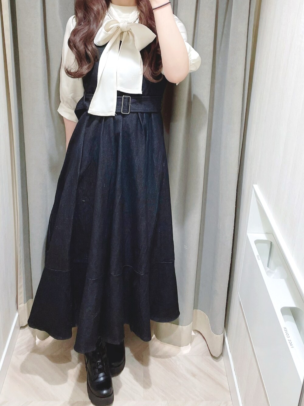 ブラック系のワンピース、ブラック系のブーツ、ホワイト系のシャツ/ブラウスを着用したレディースの春コーディネートの1枚目の写真