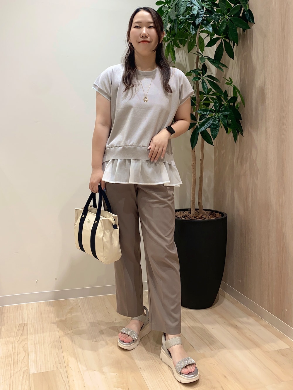 グレー系のニット/セーター、ベージュ系のその他パンツ、ブラック系のトートバッグを着用したレディースの夏コーディネートの1枚目の写真