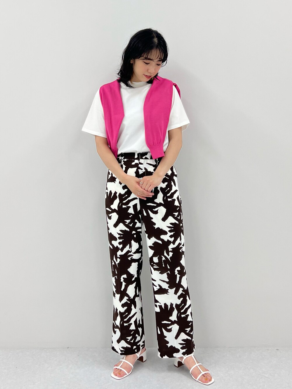 ホワイト系のTシャツ/カットソー、ブラウン系のその他パンツ、オレンジ系のカーディガン/ボレロを着用したレディースの春コーディネートの1枚目の写真