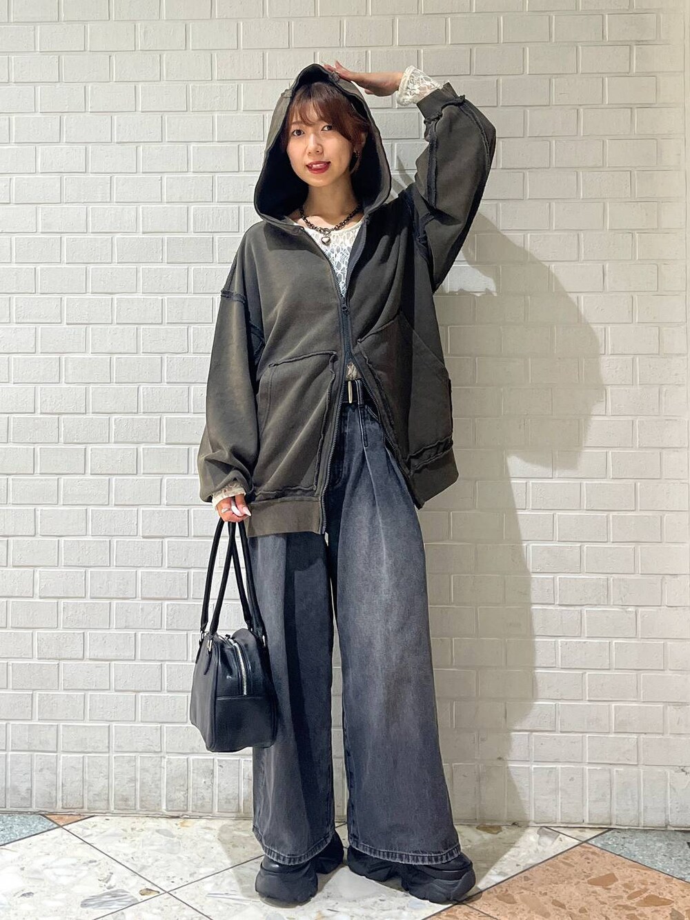 ブラック系のブーツ、ブラック系のデニムパンツ、ホワイト系のTシャツ/カットソーを着用したレディースの秋コーディネートの1枚目の写真