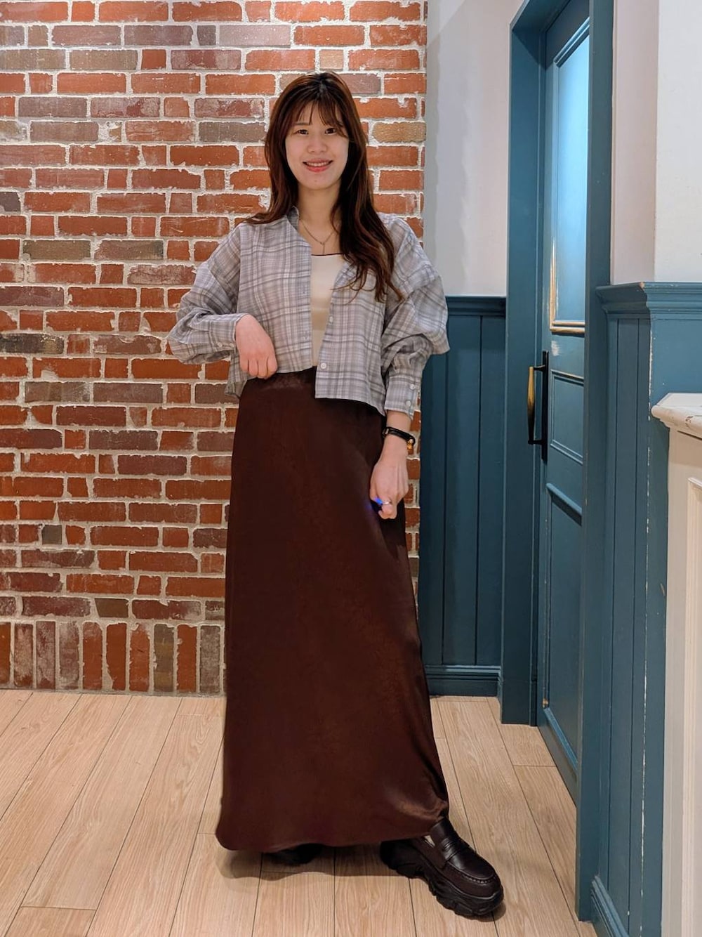 ブラウン系のスカート、その他のシャツ/ブラウス、ブラック系のローファーを着用したレディースの春コーディネートの1枚目の写真