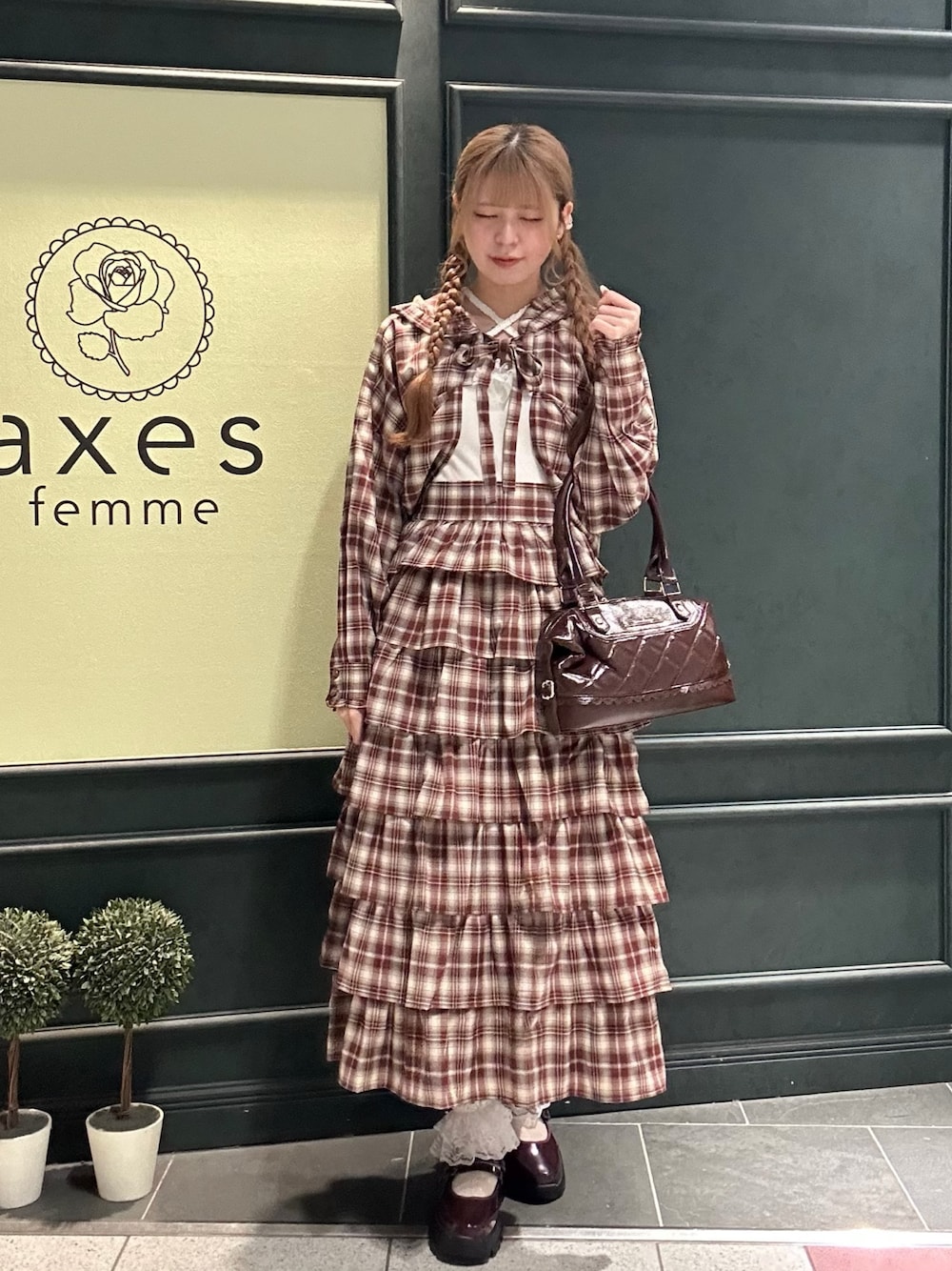 レッド系のスカート、レッド系のシャツ/ブラウス、ホワイト系のタンクトップを着用したレディースの秋コーディネートの1枚目の写真