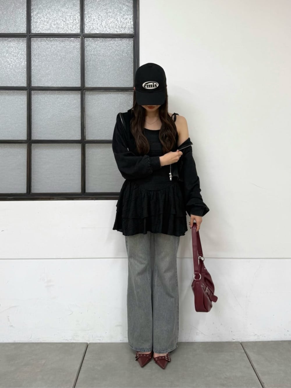 ブルー系のデニムパンツ、ブラック系のパーカー、ブラック系のワンピースを着用したレディースの春コーディネートの1枚目の写真