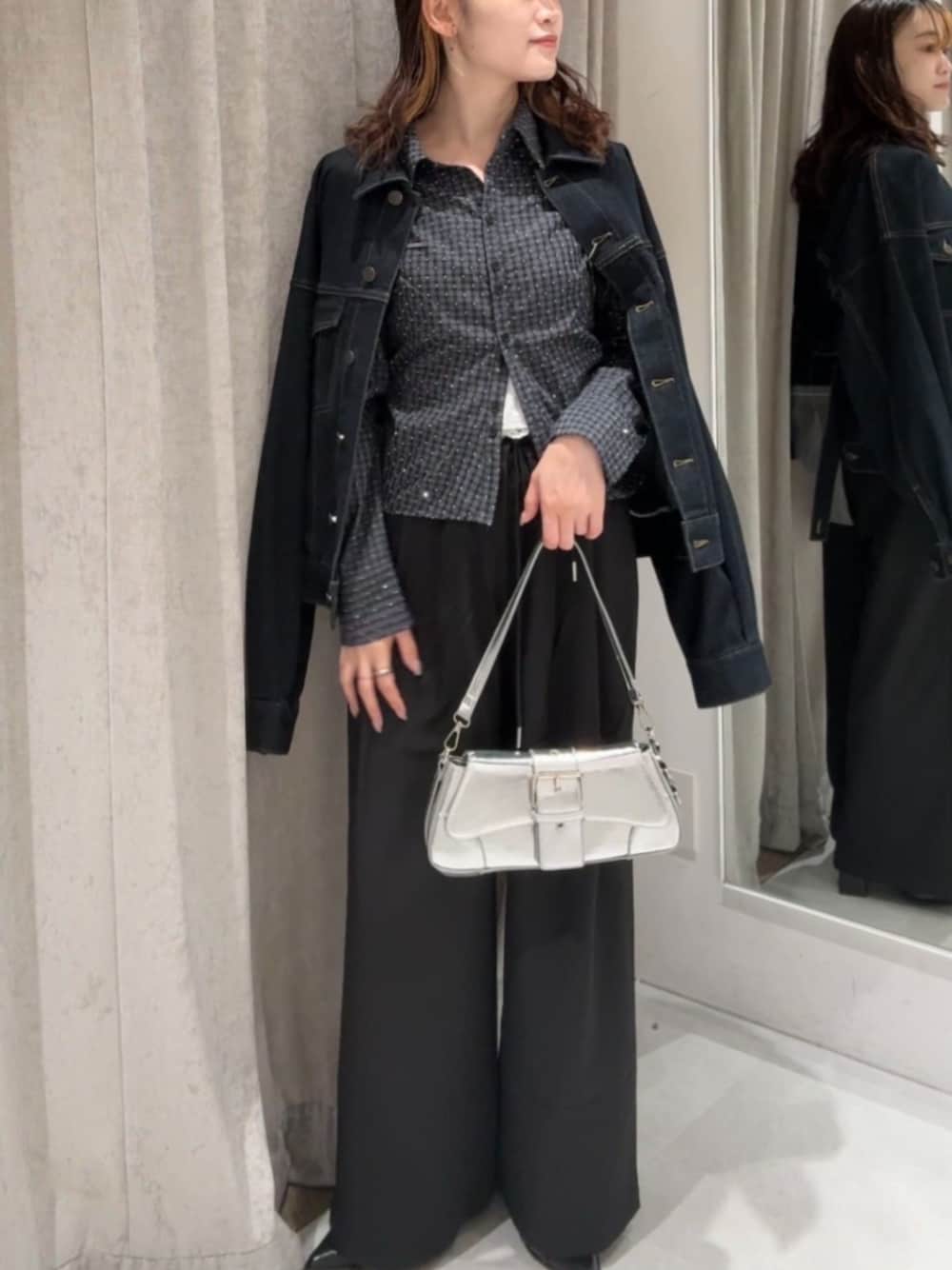 ブルー系のデニムジャケット、ブラック系のスラックス、グレー系のシャツ/ブラウスを着用したレディースの秋コーディネートの1枚目の写真