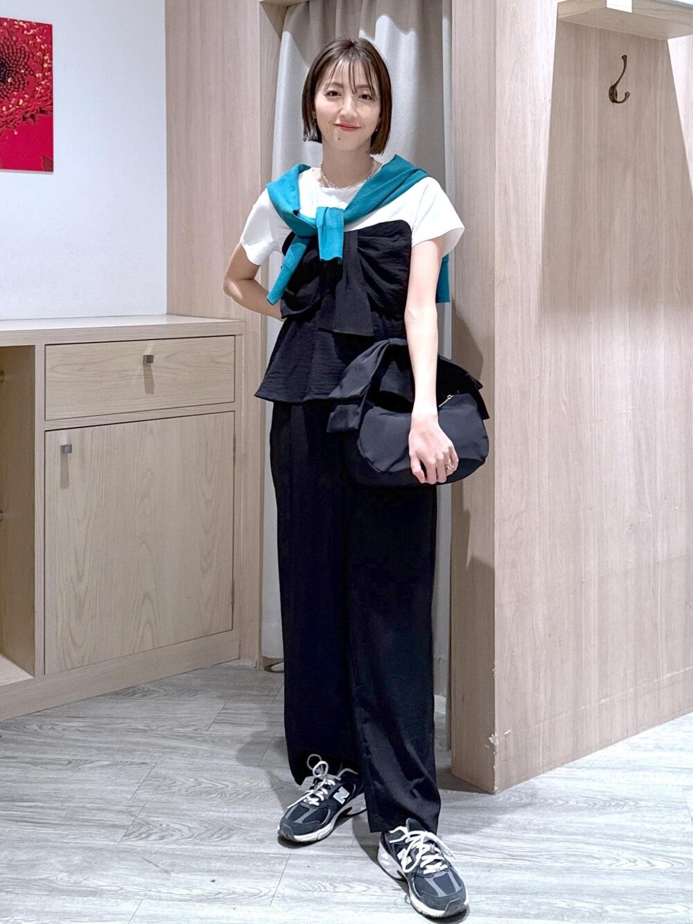 ブルー系のカーディガン/ボレロ、ブラック系のTシャツ/カットソー、ブラック系のスラックスを着用したレディースの春コーディネートの1枚目の写真