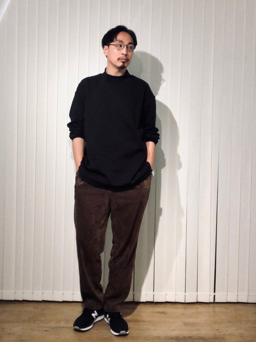 ブラック系のTシャツ/カットソー、ブラウン系のその他パンツ、ブラック系のスニーカーを着用したメンズの秋コーディネートの1枚目の写真