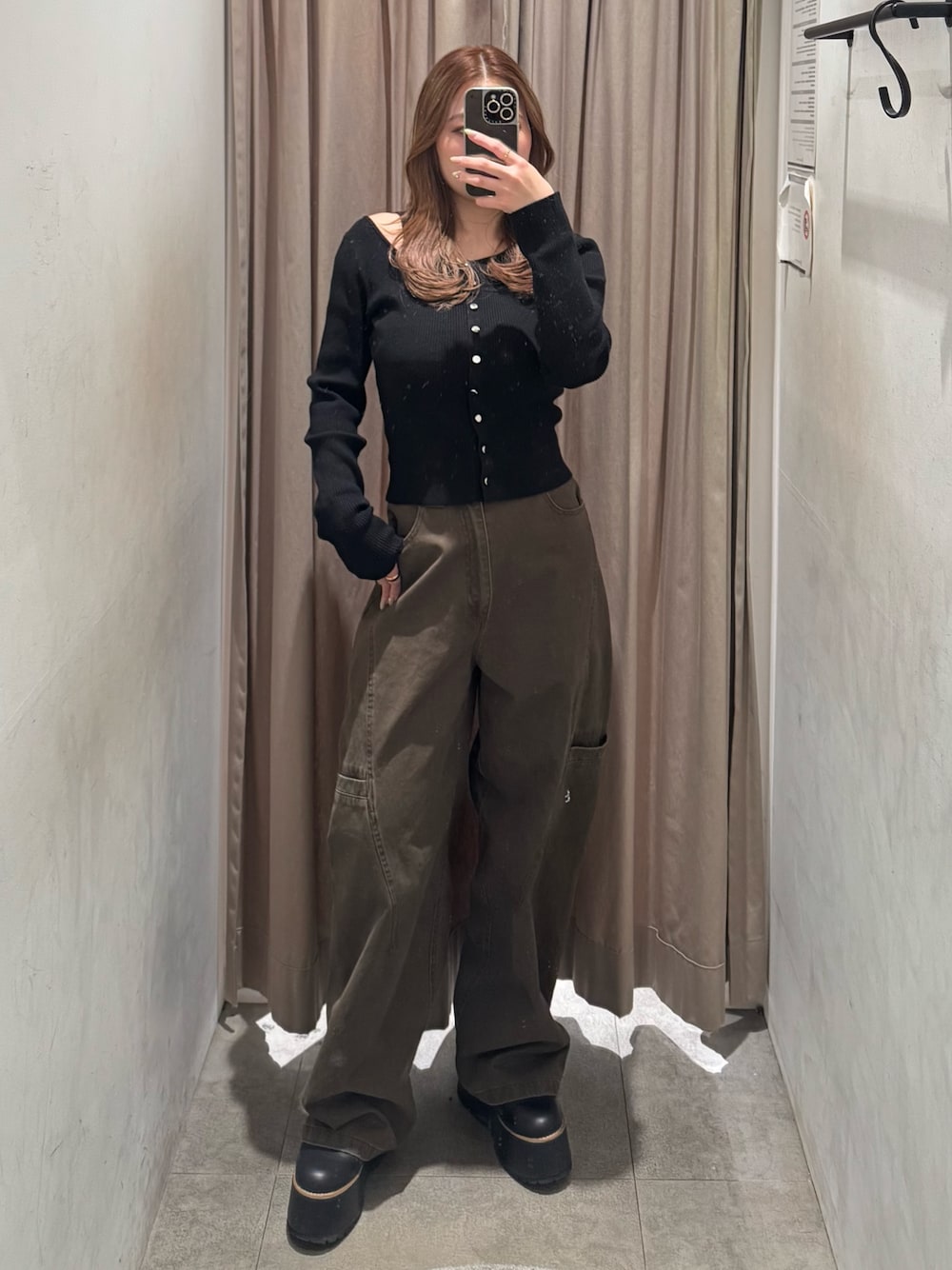 ブラウン系のその他パンツ、ブラック系のニット/セーター、ブラック系のブーツを着用したレディースの冬コーディネートの1枚目の写真