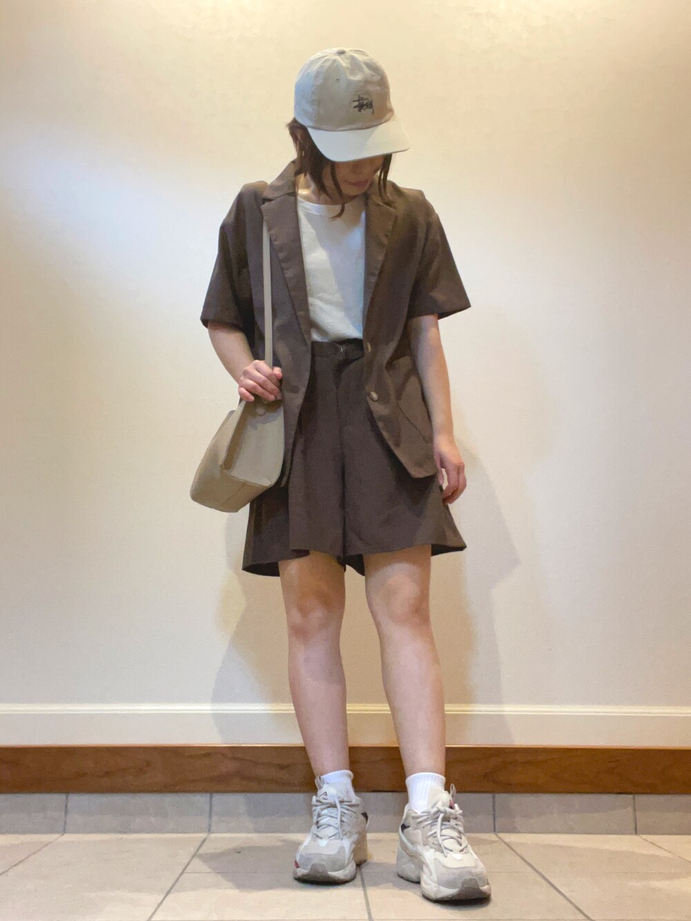 ベージュ系のスニーカー、ブラウン系のシャツ/ブラウス、ブラウン系のパンツを着用したレディースの夏コーディネートの1枚目の写真