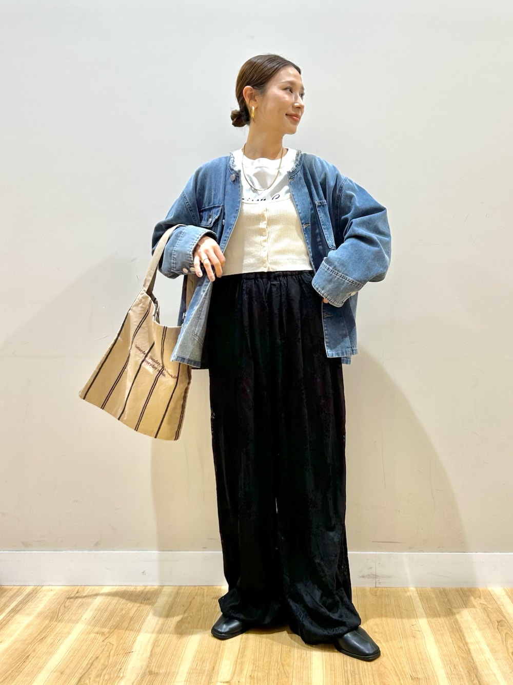 ブルー系のデニムジャケット、ホワイト系のベスト、ホワイト系のTシャツ/カットソーを着用したレディースの冬コーディネートの1枚目の写真