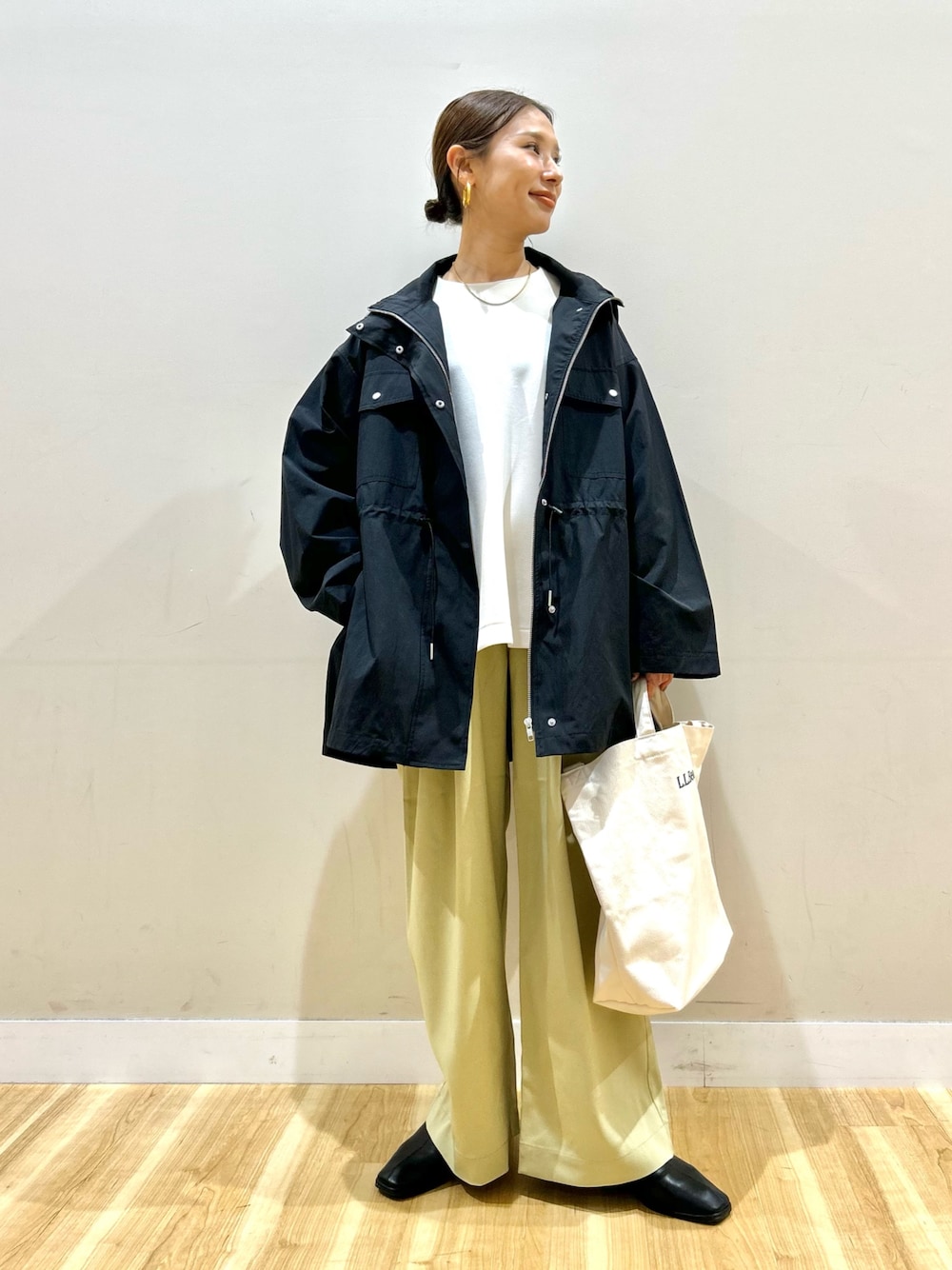 ブラック系のブルゾン、ホワイト系のスウェット、ベージュ系のその他パンツを着用したレディースの春コーディネートの1枚目の写真