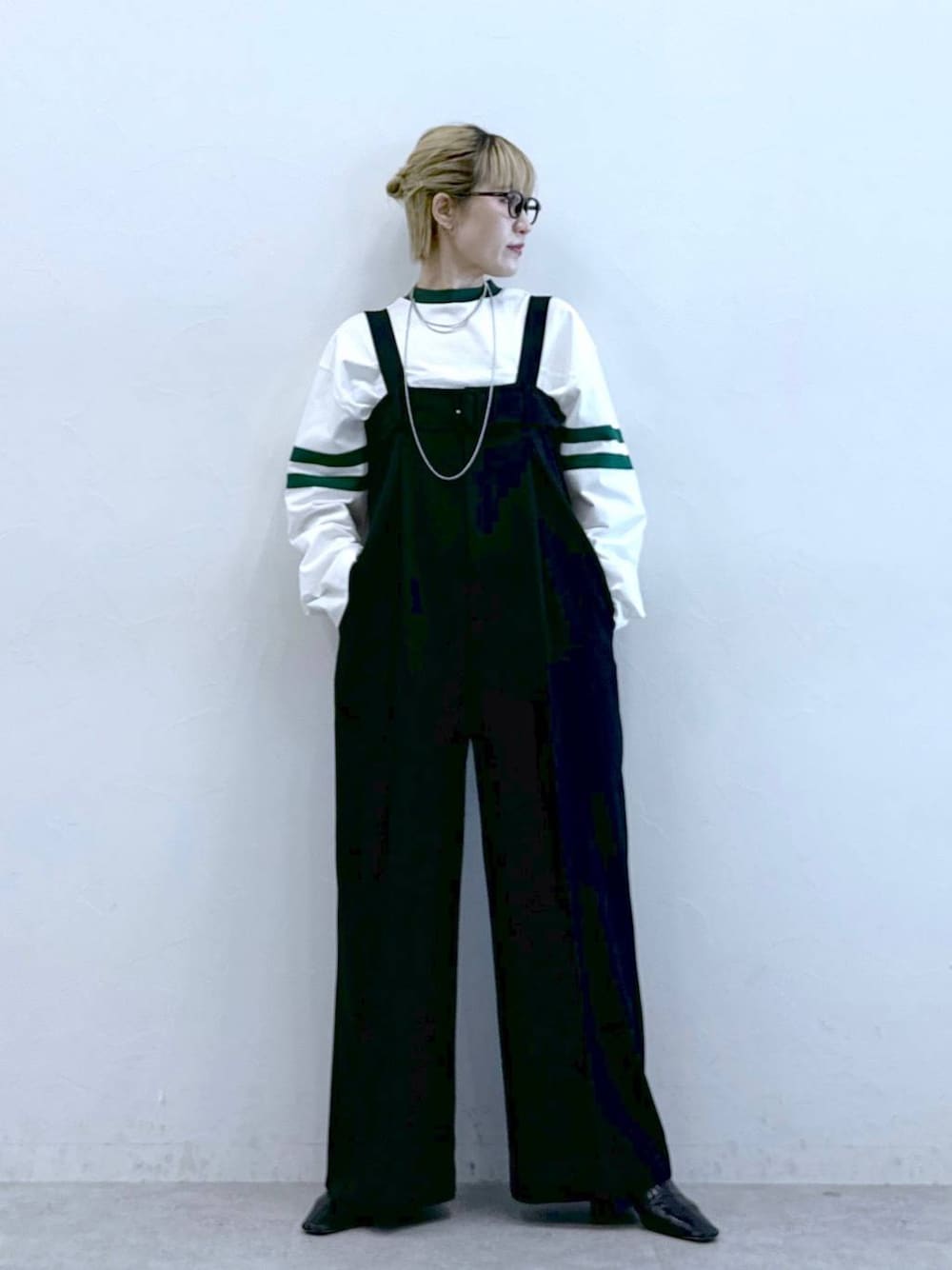 ブラック系のサロペット/オーバーオール、ホワイト系のTシャツ/カットソーを着用したレディースの冬コーディネートの1枚目の写真
