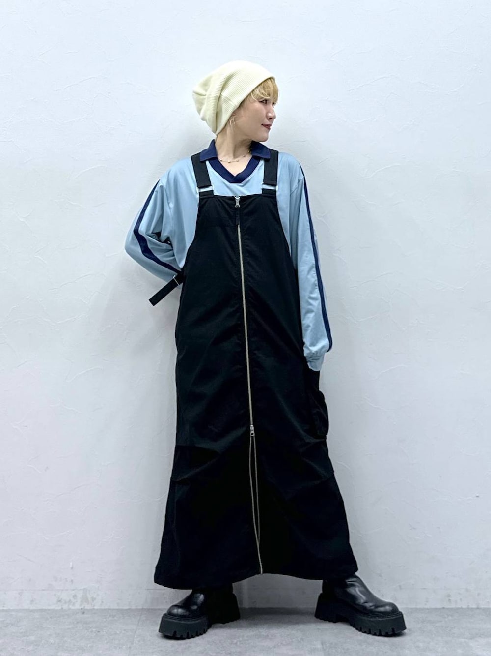 ブラック系のジャンパースカート、ブルー系のTシャツ/カットソーを着用したレディースの秋コーディネートの1枚目の写真