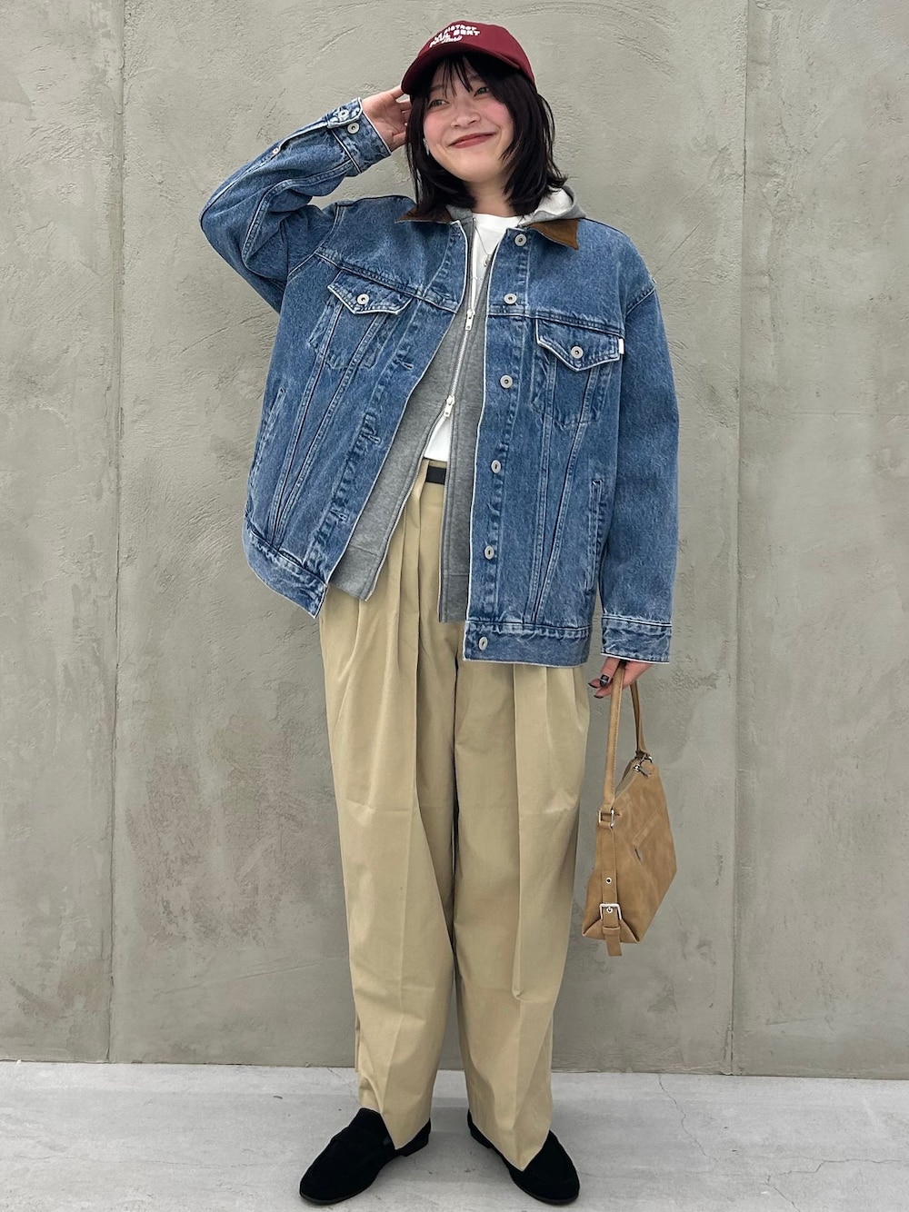 ブルー系のデニムジャケット、ベージュ系のチノパンツ、グレー系のパーカーを着用したレディースの冬コーディネートの1枚目の写真