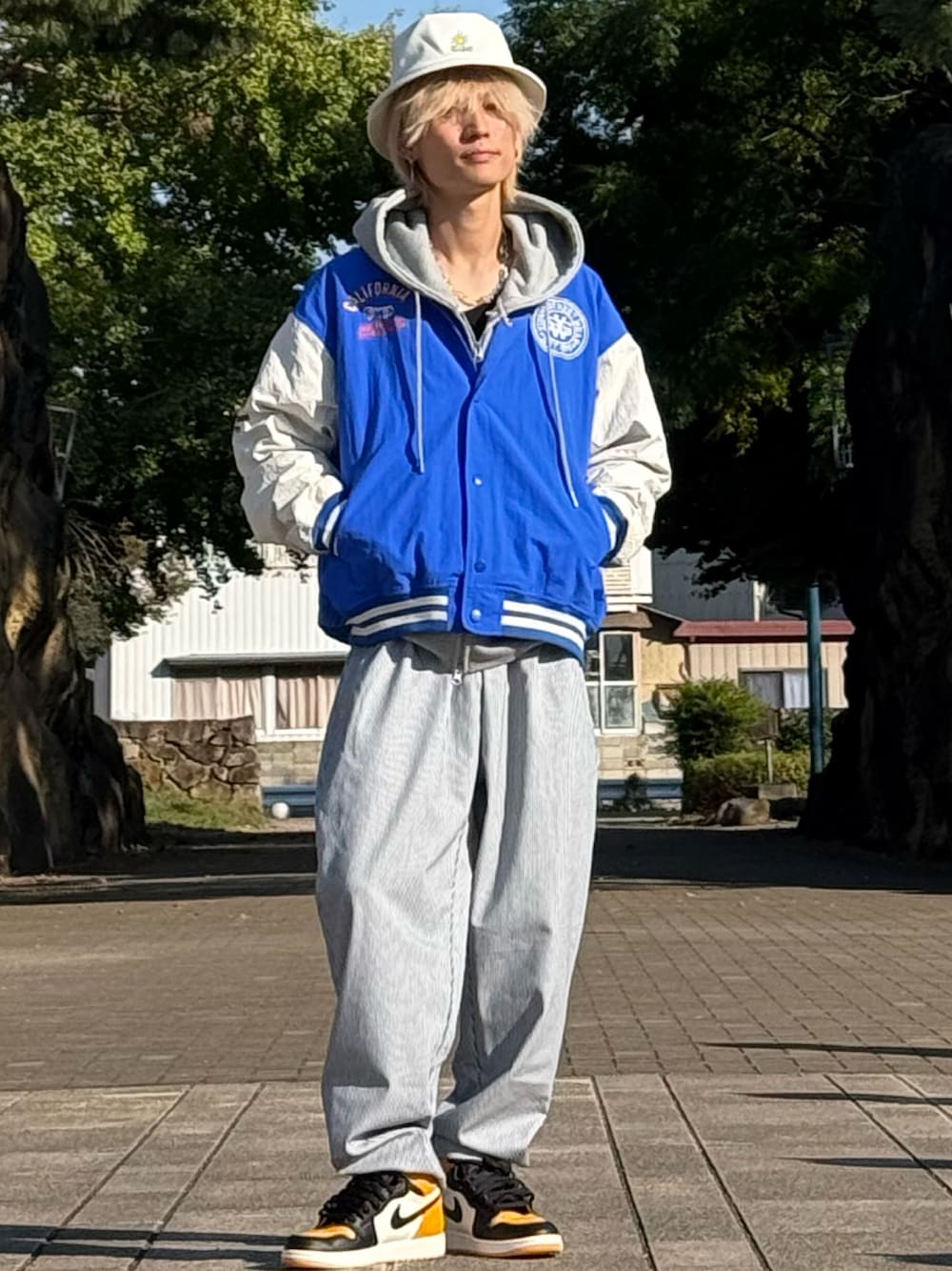 イエロー系のスニーカーを着用したメンズの秋コーディネートの1枚目の写真