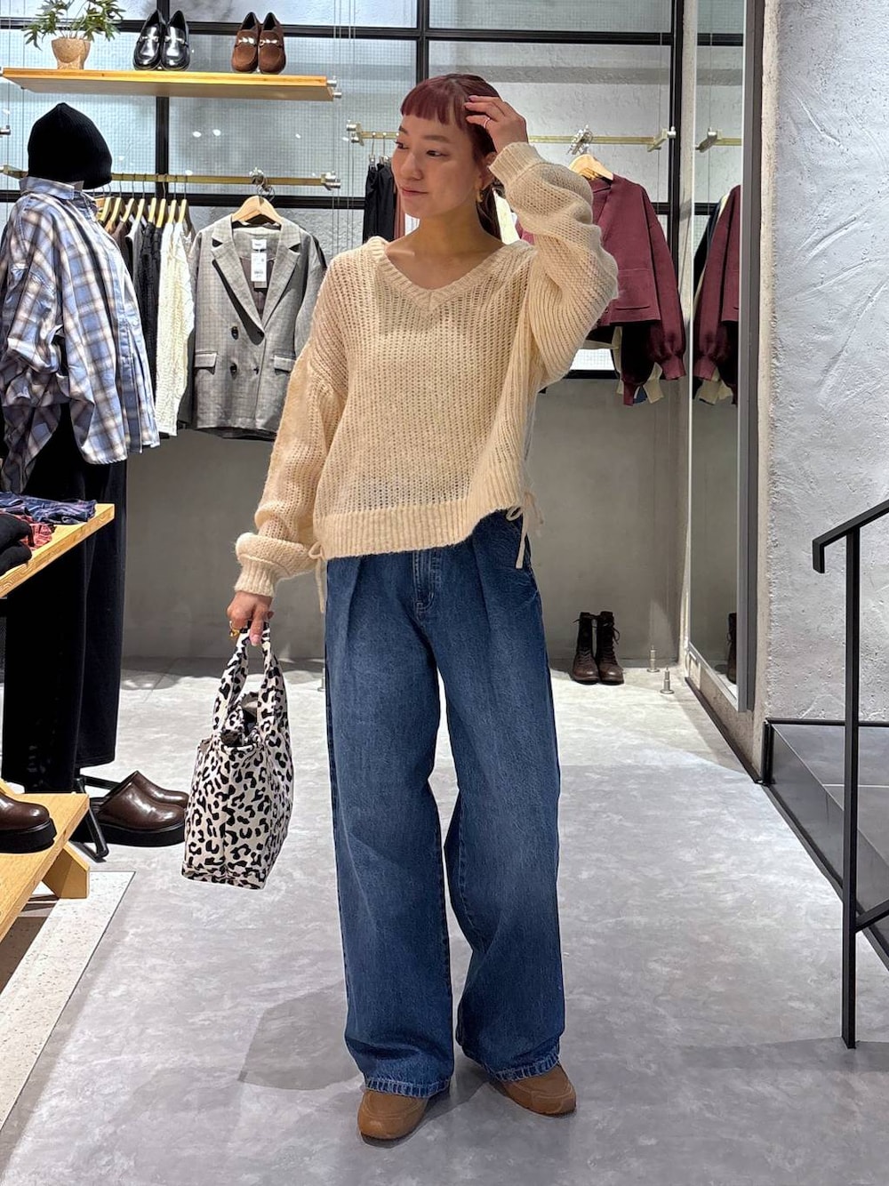 ゴールド系のタンクトップ、その他のショルダーバッグ、ブルー系のデニムパンツを着用したレディースの秋コーディネートの1枚目の写真