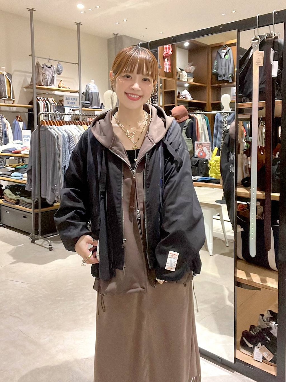 ブラウン系のスカート、ブラウン系のパーカー、ベージュ系のその他パンツを着用したレディースの秋コーディネートの1枚目の写真