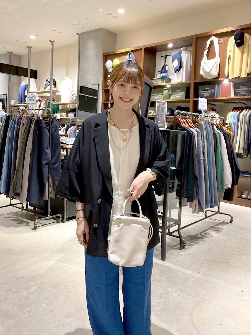 ホワイト系のシャツ/ブラウス、ブルー系のその他パンツ、ブラック系のテーラードジャケットを着用したレディースの春コーディネートの1枚目の写真