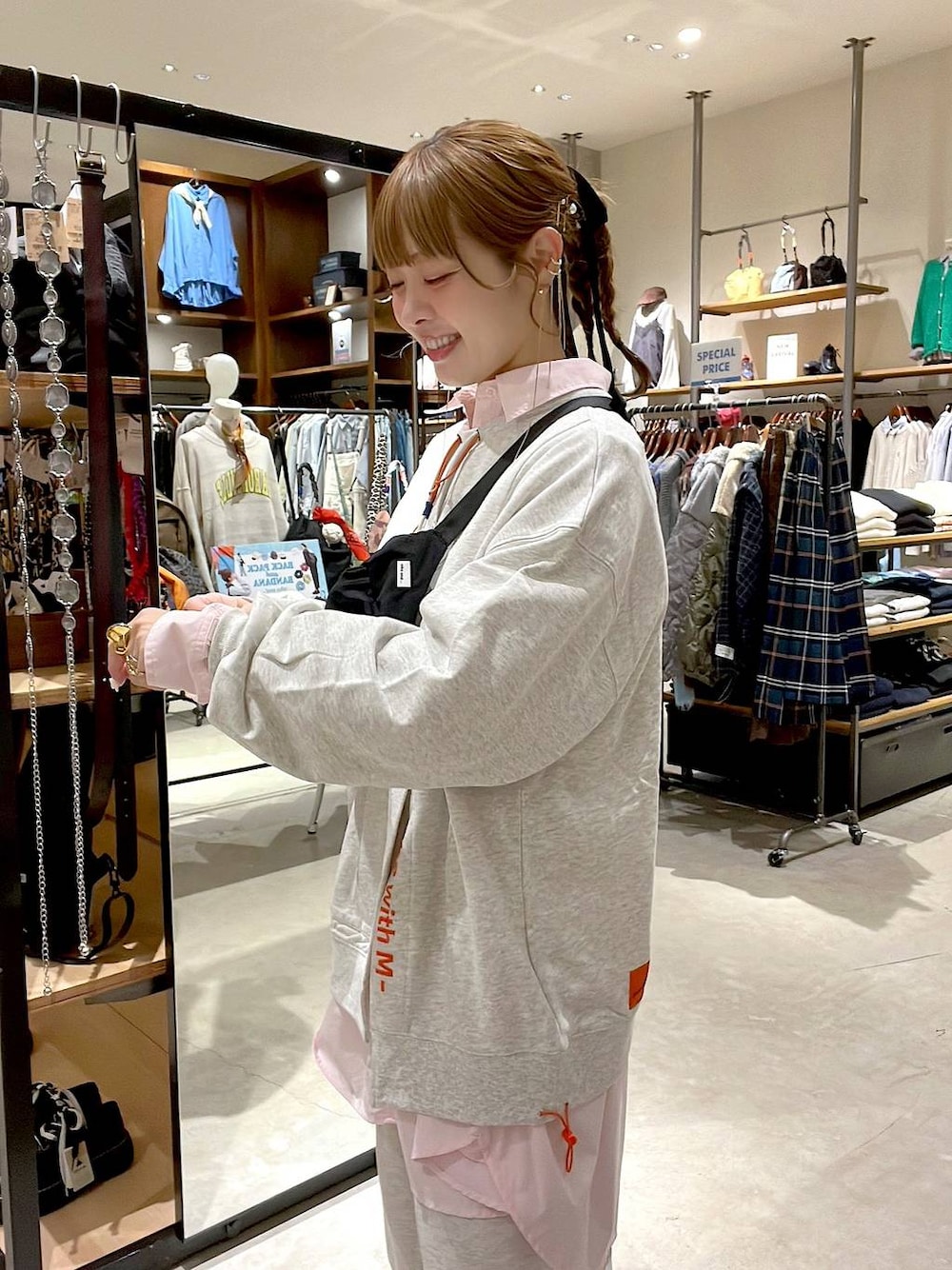 グレー系のスウェットパンツ、ピンク系のシャツ/ブラウス、ブラック系のボディバッグ/ウエストポーチを着用したレディースの冬コーディネートの1枚目の写真