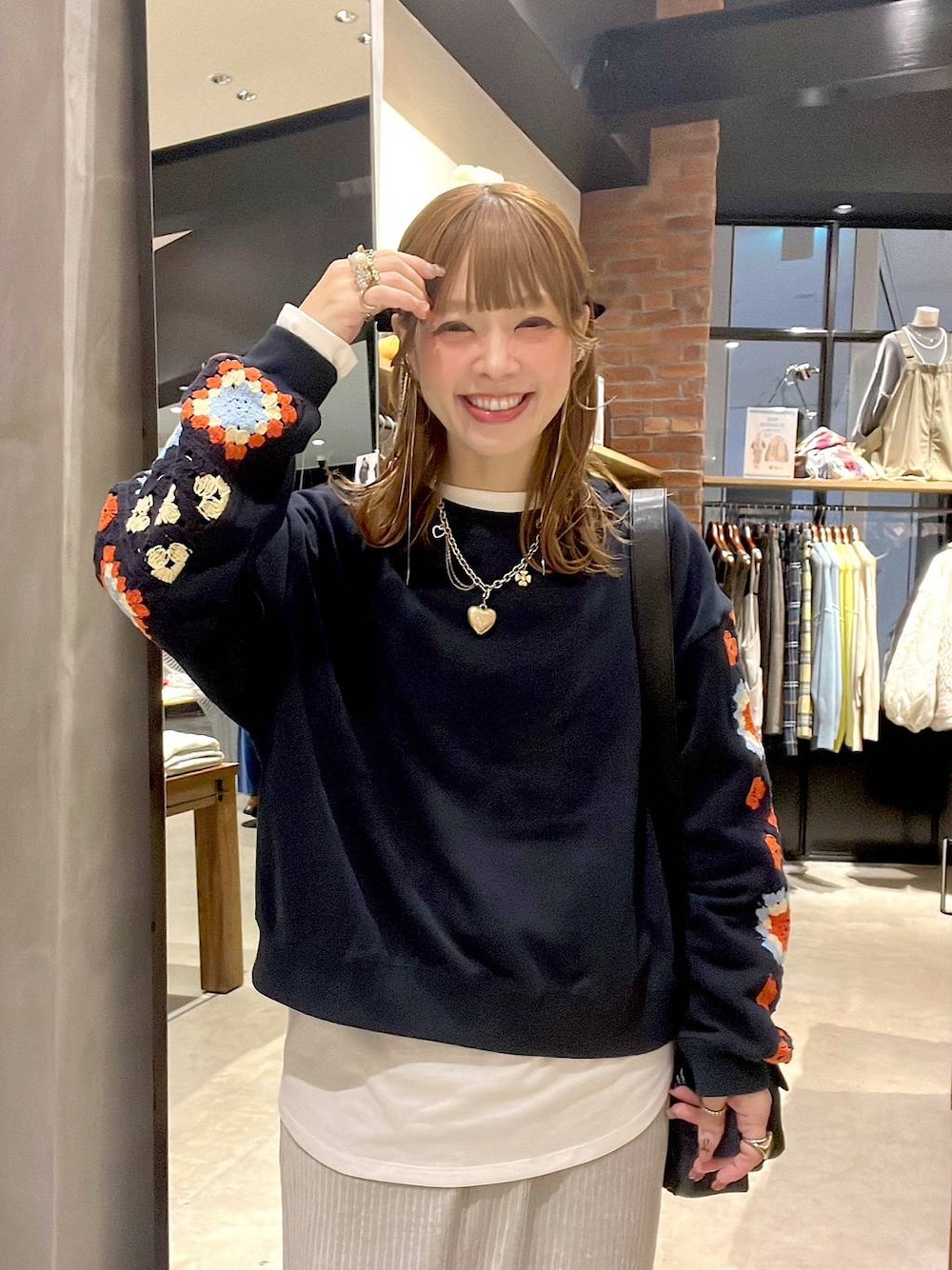 ブルー系のスウェット、ホワイト系のTシャツ/カットソー、グレー系のスカートを着用したレディースの冬コーディネートの1枚目の写真