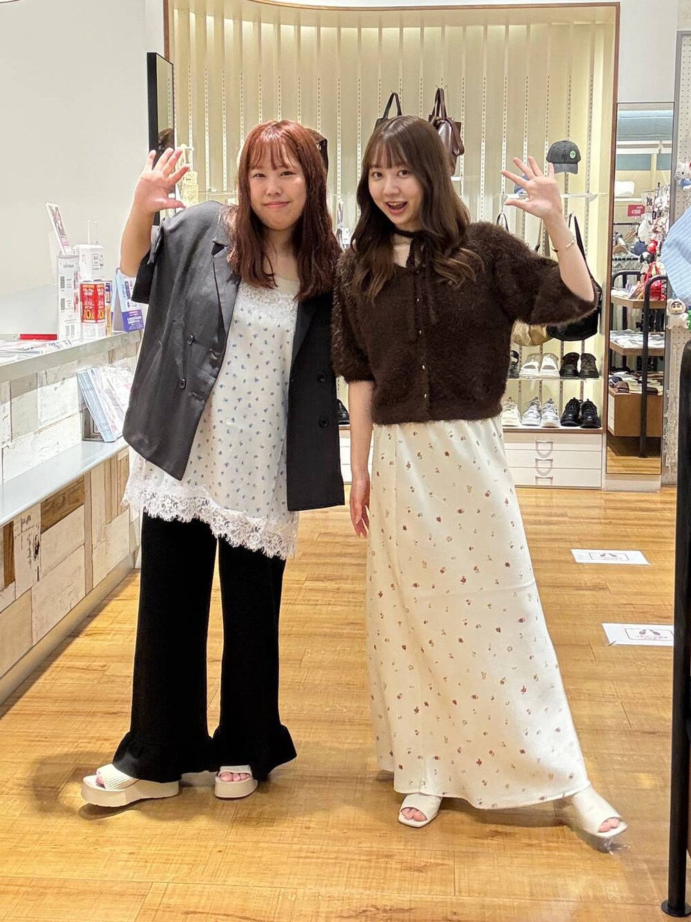 ブラウン系のカーディガン/ボレロ、ホワイト系のスカート、ホワイト系のサンダルを着用したレディースの秋コーディネートの1枚目の写真