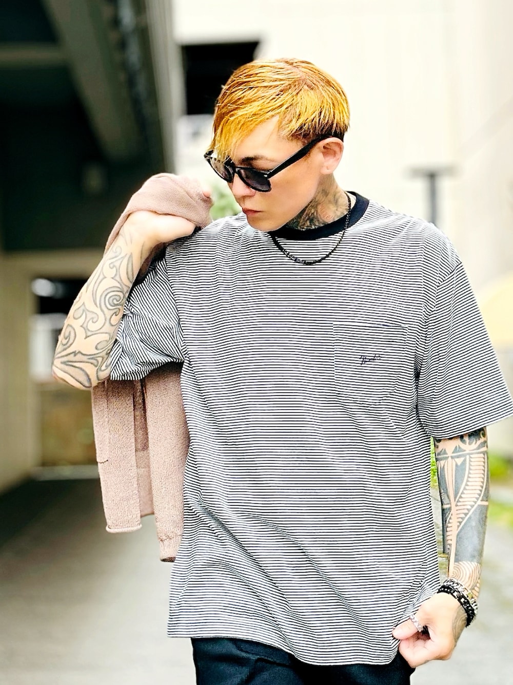 ブラック系のTシャツ/カットソー、ベージュ系のカーディガン/ボレロ、ブラック系のデニムパンツを着用したメンズの秋コーディネートの1枚目の写真