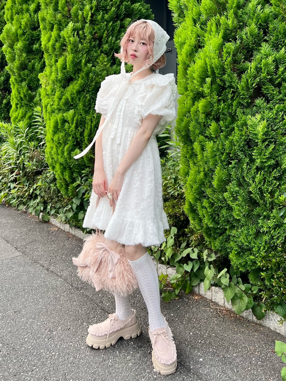 ホワイト系のワンピース、ピンク系のボストンバッグ、ピンク系のローファーを着用したレディースの夏コーディネートの1枚目の写真