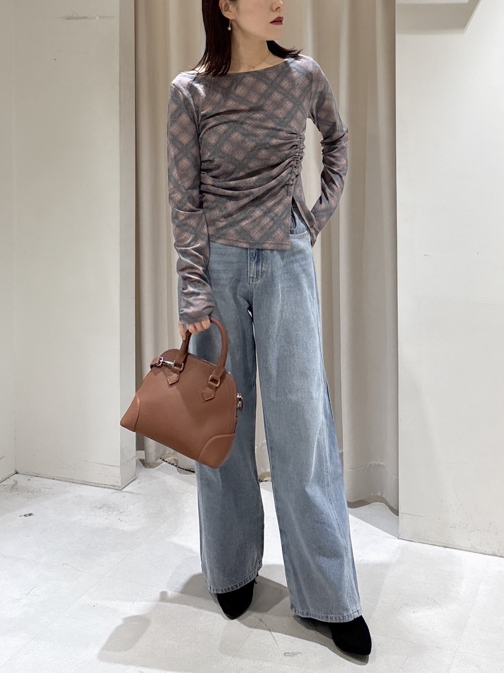 ブラウン系のTシャツ/カットソー、ブルー系のデニムパンツ、ブラウン系のショルダーバッグを着用したレディースの秋コーディネートの1枚目の写真