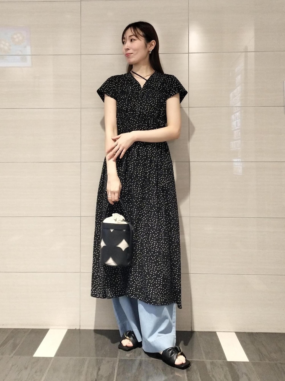 ブラック系のキャミソール、ブルー系のデニムパンツ、ブラック系のサンダルを着用したレディースの夏コーディネートの1枚目の写真