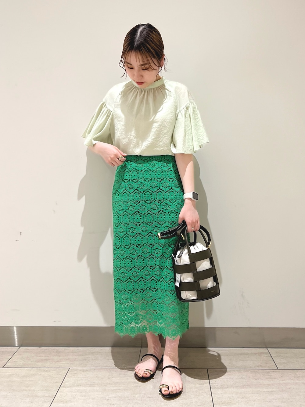 グリーン系のスカート、グリーン系のシャツ/ブラウスを着用したレディースの春コーディネートの1枚目の写真
