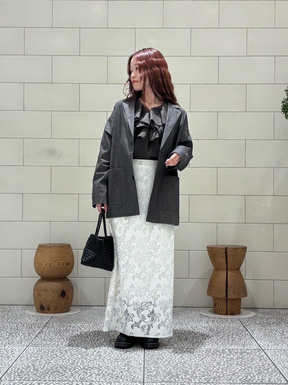 ブラウン系のシャツ/ブラウス、グレー系のその他アウター、ホワイト系のスカートを着用したレディースの春コーディネートの1枚目の写真