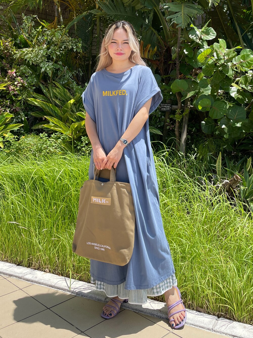 ベージュ系のショルダーバッグ、ブルー系のワンピース、グリーン系のスカートを着用したレディースの夏コーディネートの1枚目の写真