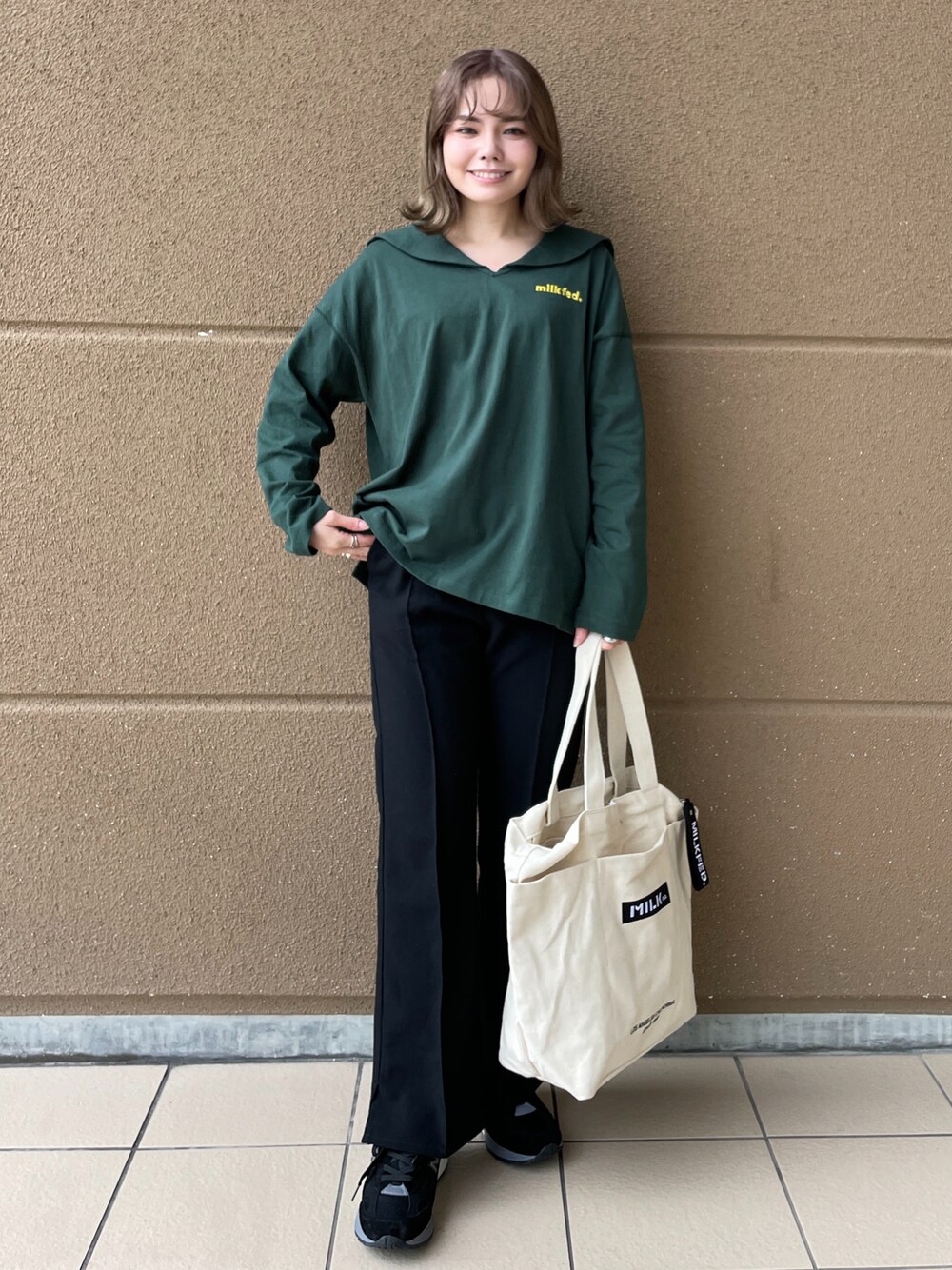 ブラック系のその他パンツ、グリーン系のTシャツ/カットソー、ホワイト系のトートバッグを着用したレディースの冬コーディネートの1枚目の写真