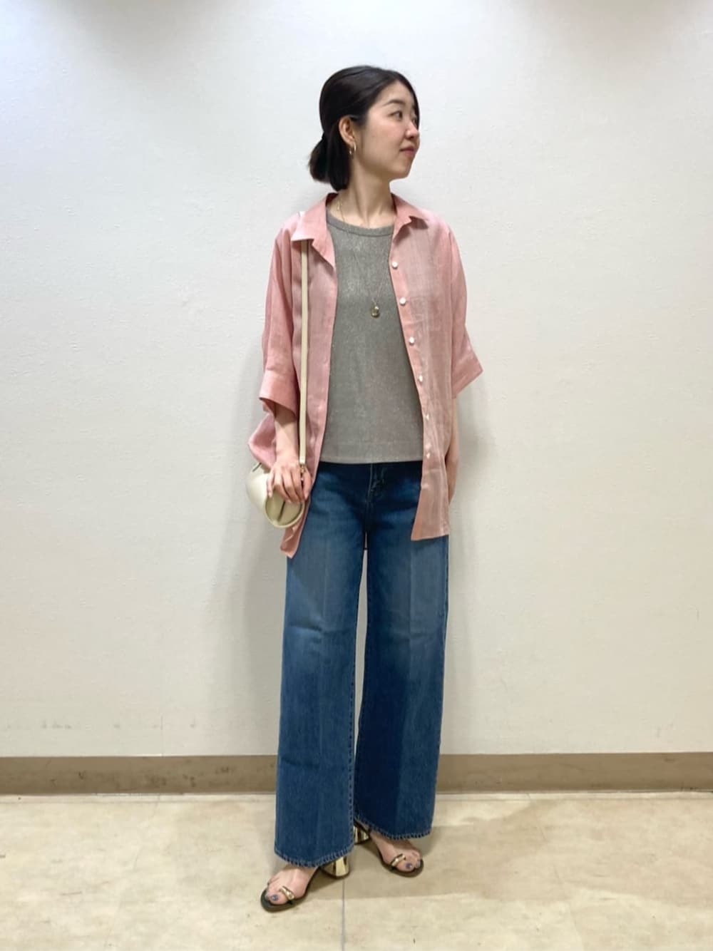ブルー系のデニムパンツ、レッド系のシャツ/ブラウスを着用したレディースの春コーディネートの1枚目の写真