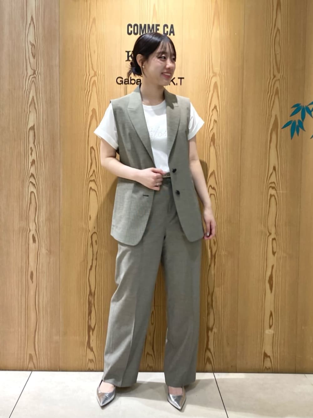 シルバー系のパンプス、ホワイト系のTシャツ/カットソー、ブラック系のベストを着用したレディースの夏コーディネートの1枚目の写真