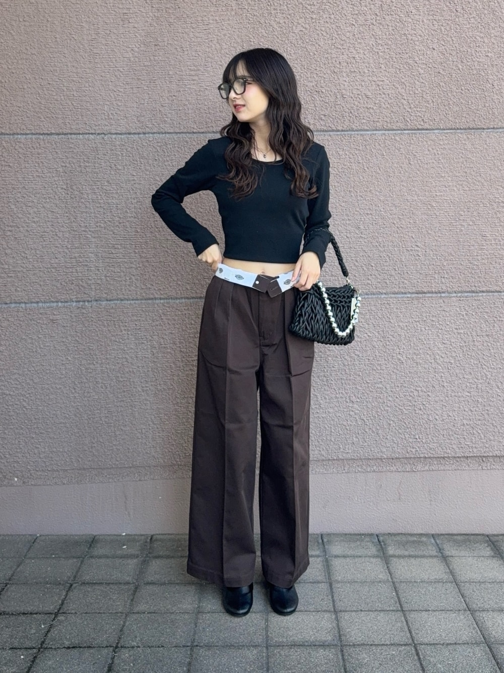 ブラック系のハンドバッグ、ブラック系のTシャツ/カットソー、ブラウン系のその他パンツを着用したレディースの秋コーディネートの1枚目の写真