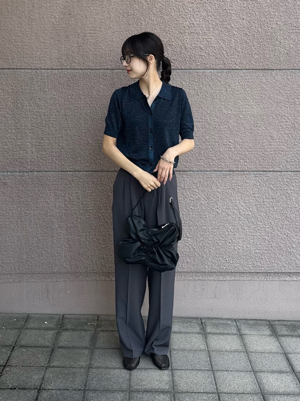 ブルー系のニット/セーター、グレー系のその他パンツ、ブラック系のハンドバッグを着用したレディースの秋コーディネートの1枚目の写真