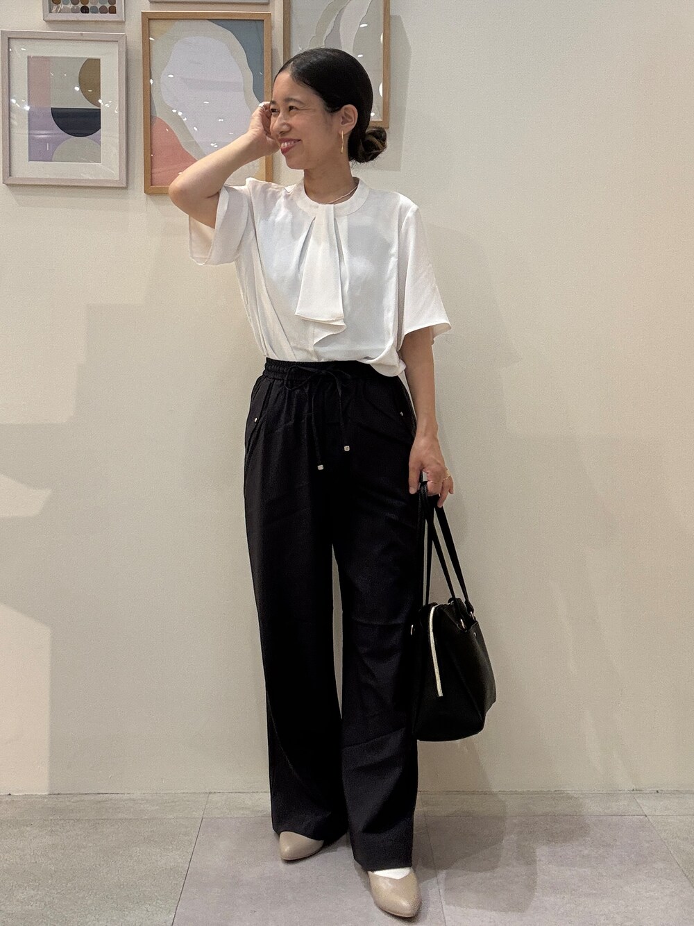 ホワイト系のシャツ/ブラウス、グレー系のその他パンツ、ブラック系のトートバッグを着用したレディースの春コーディネートの1枚目の写真