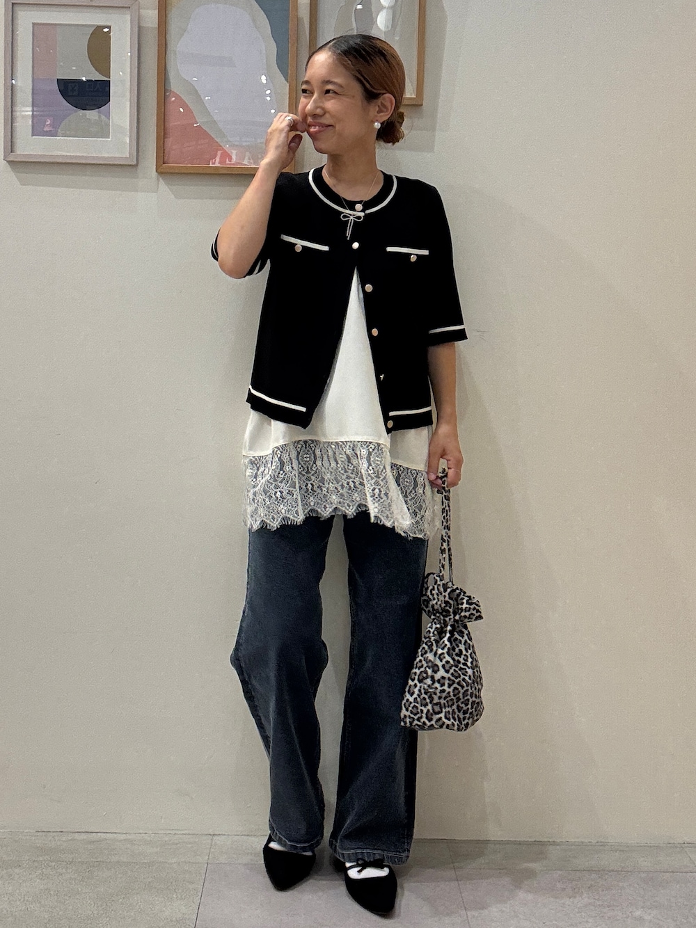 ブラック系のカーディガン/ボレロ、ホワイト系のTシャツ/カットソー、ブルー系のデニムパンツを着用したレディースの夏コーディネートの1枚目の写真