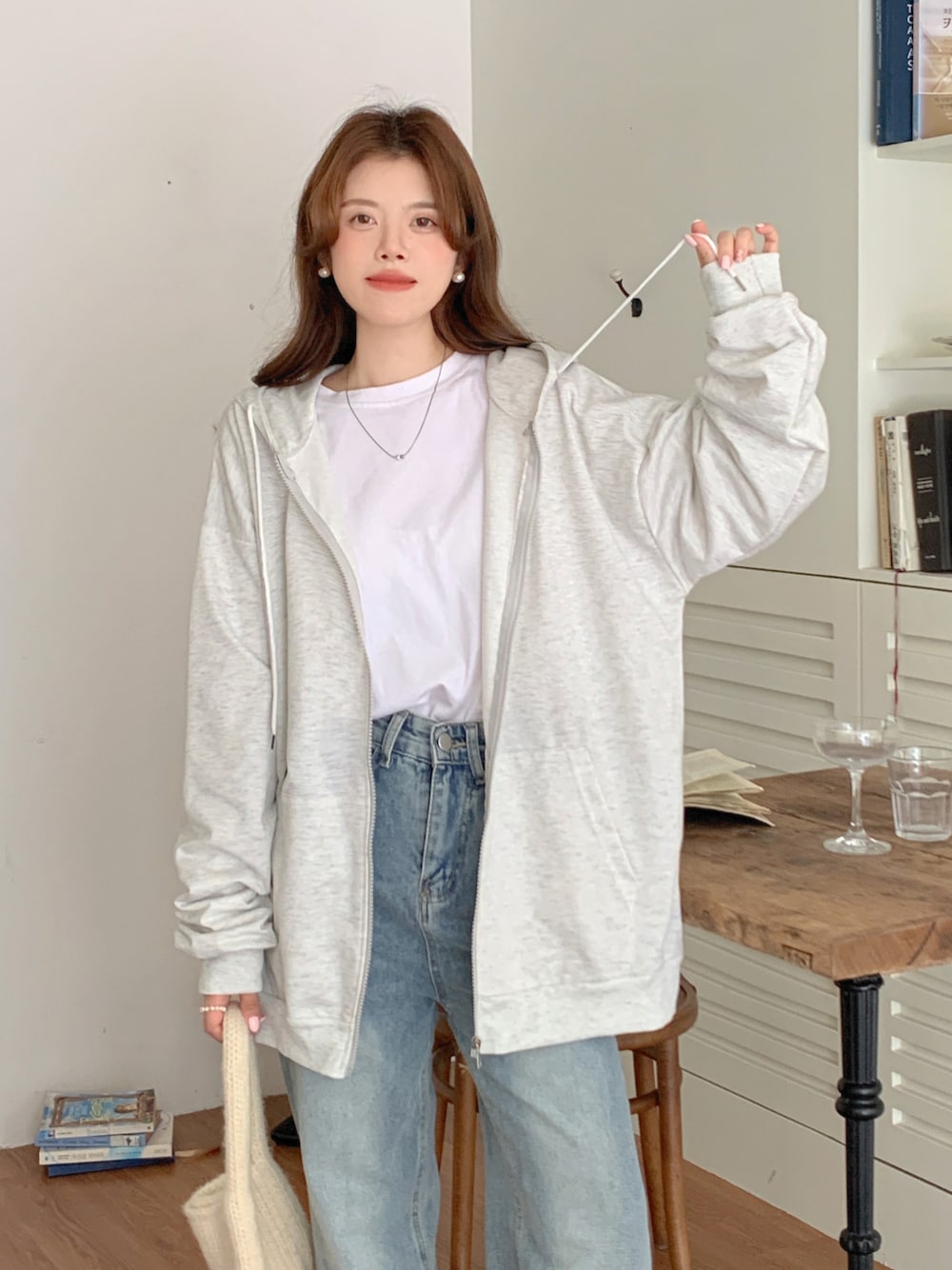 ベージュ系のパーカーを着用したレディースの秋コーディネートの1枚目の写真