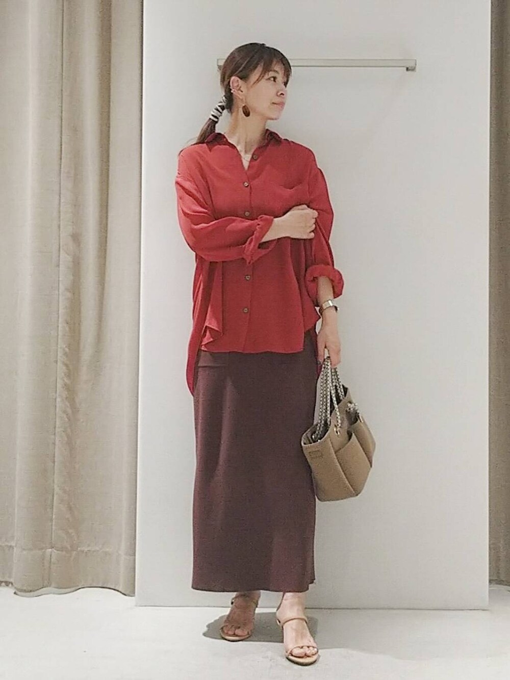 ベージュ系のスリッポン、ブラウン系のトートバッグ、レッド系のシャツ/ブラウスを着用したレディースの夏コーディネートの1枚目の写真