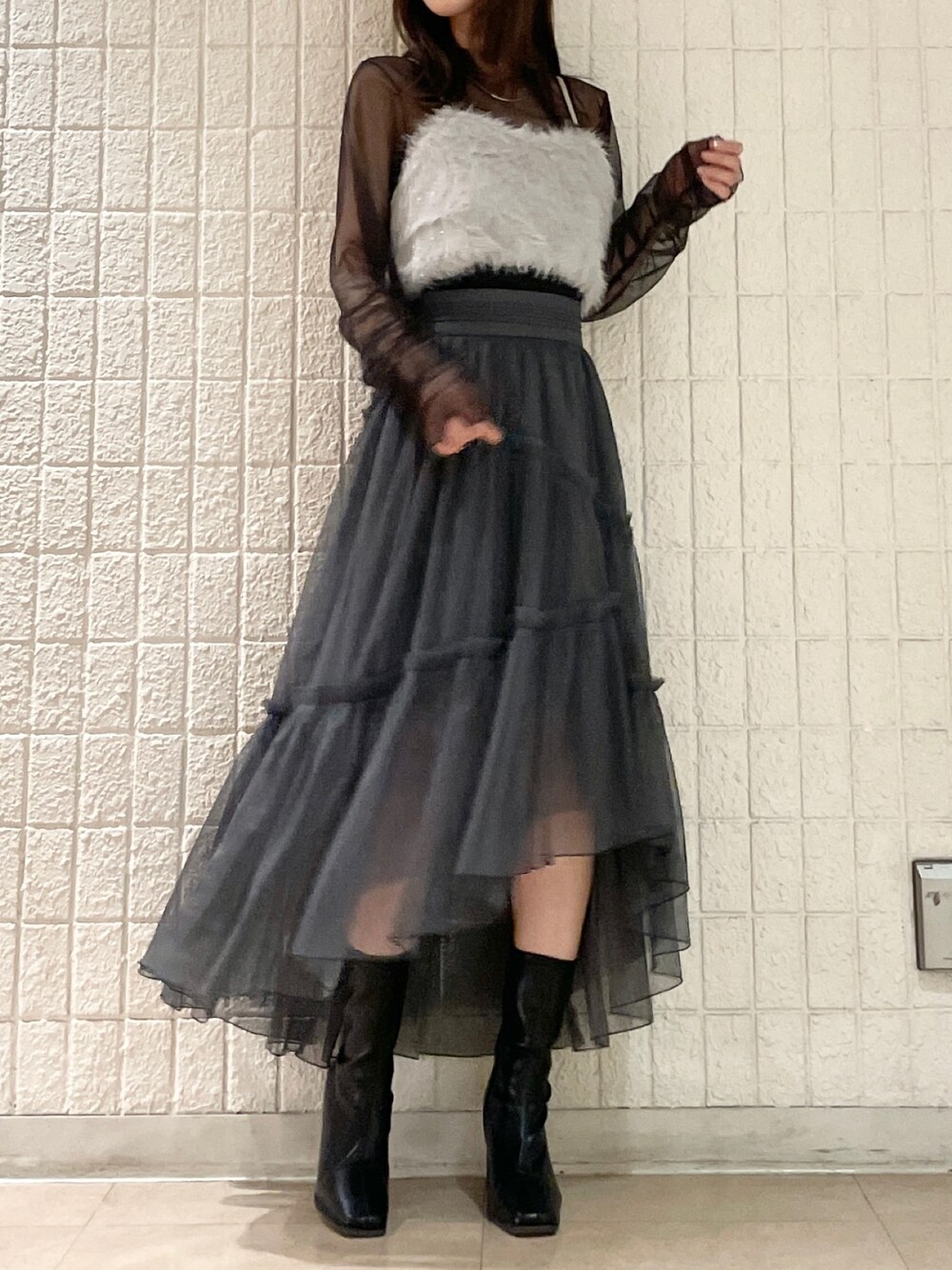 グレー系のスカート、ブラック系のブーツ、グレー系のTシャツ/カットソーを着用したレディースの夏コーディネートの1枚目の写真
