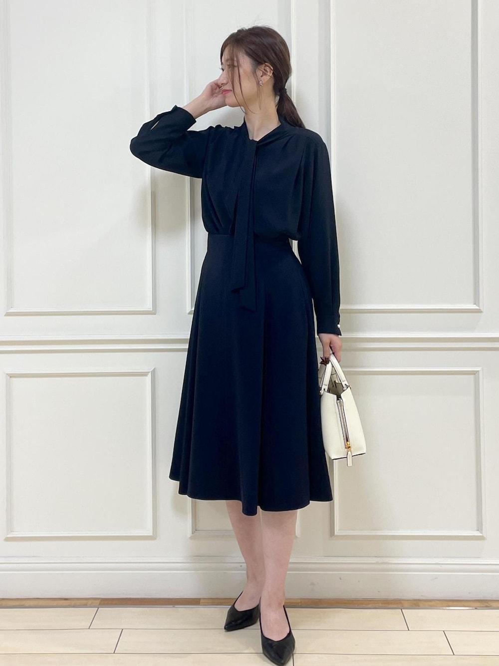 ホワイト系のハンドバッグ、ブルー系のシャツ/ブラウス、ブルー系のスカートを着用したレディースの秋コーディネートの1枚目の写真