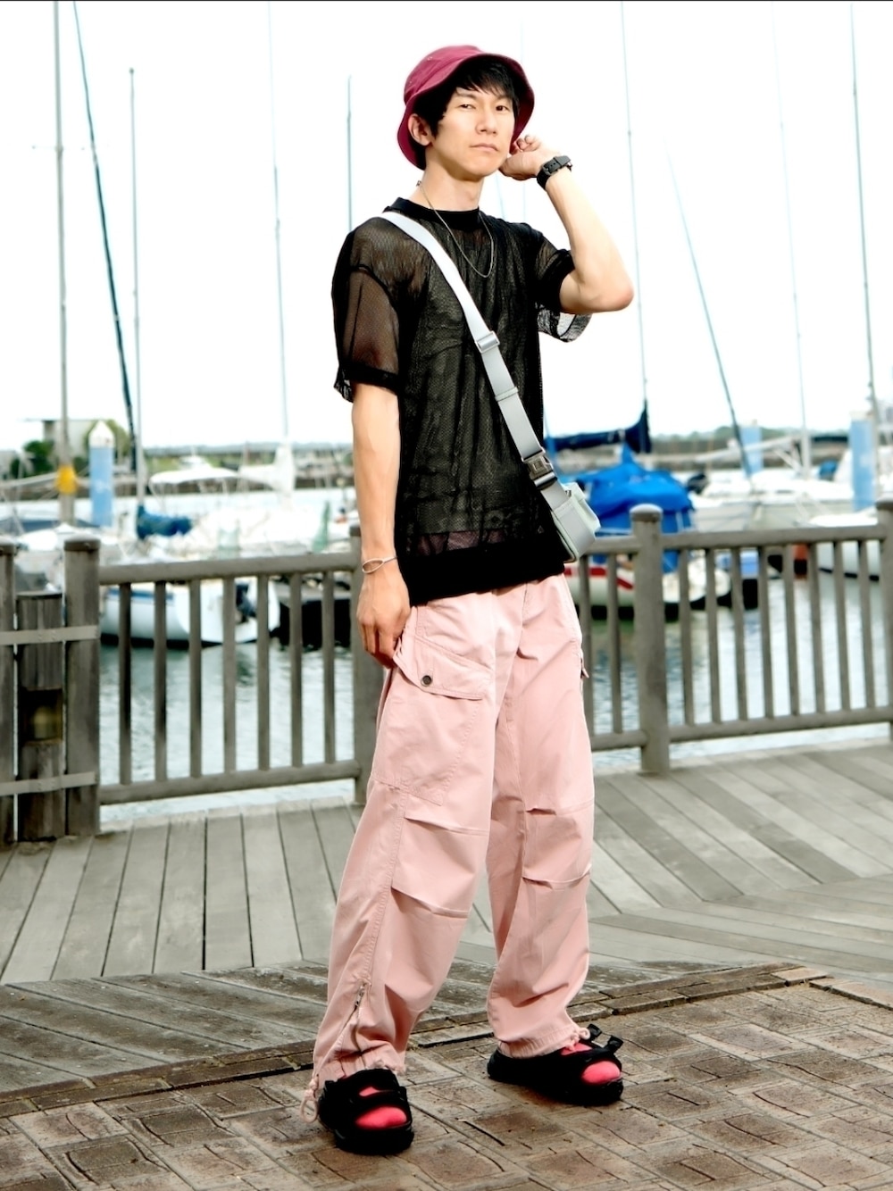 ブラック系のTシャツ/カットソー、グリーン系のショルダーバッグ、ピンク系のカーゴパンツを着用したメンズの夏コーディネートの1枚目の写真