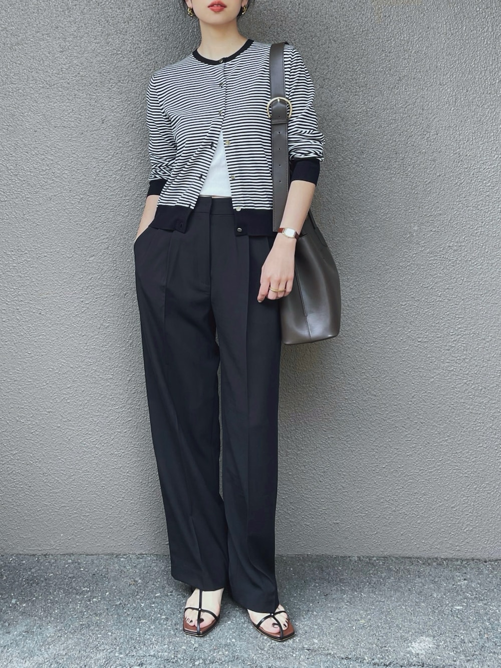 ホワイト系のカーディガン/ボレロ、ブラック系のスラックス、ホワイト系のキャミソールを着用したレディースの春コーディネートの1枚目の写真