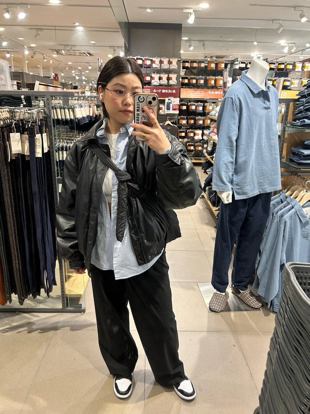 ブラック系のパンツ、ブラック系のスニーカー、ブラック系のブルゾンを着用したレディースの冬コーディネートの1枚目の写真