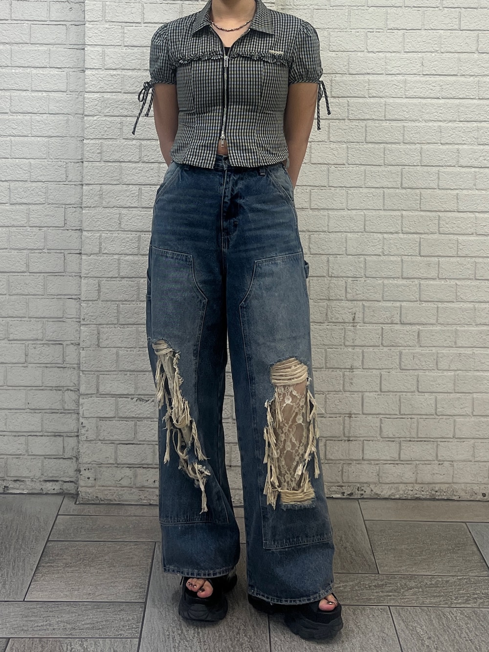 ブラック系のシャツ/ブラウス、ブルー系のデニムパンツ、ブラック系のサンダルを着用したレディースの春コーディネートの1枚目の写真