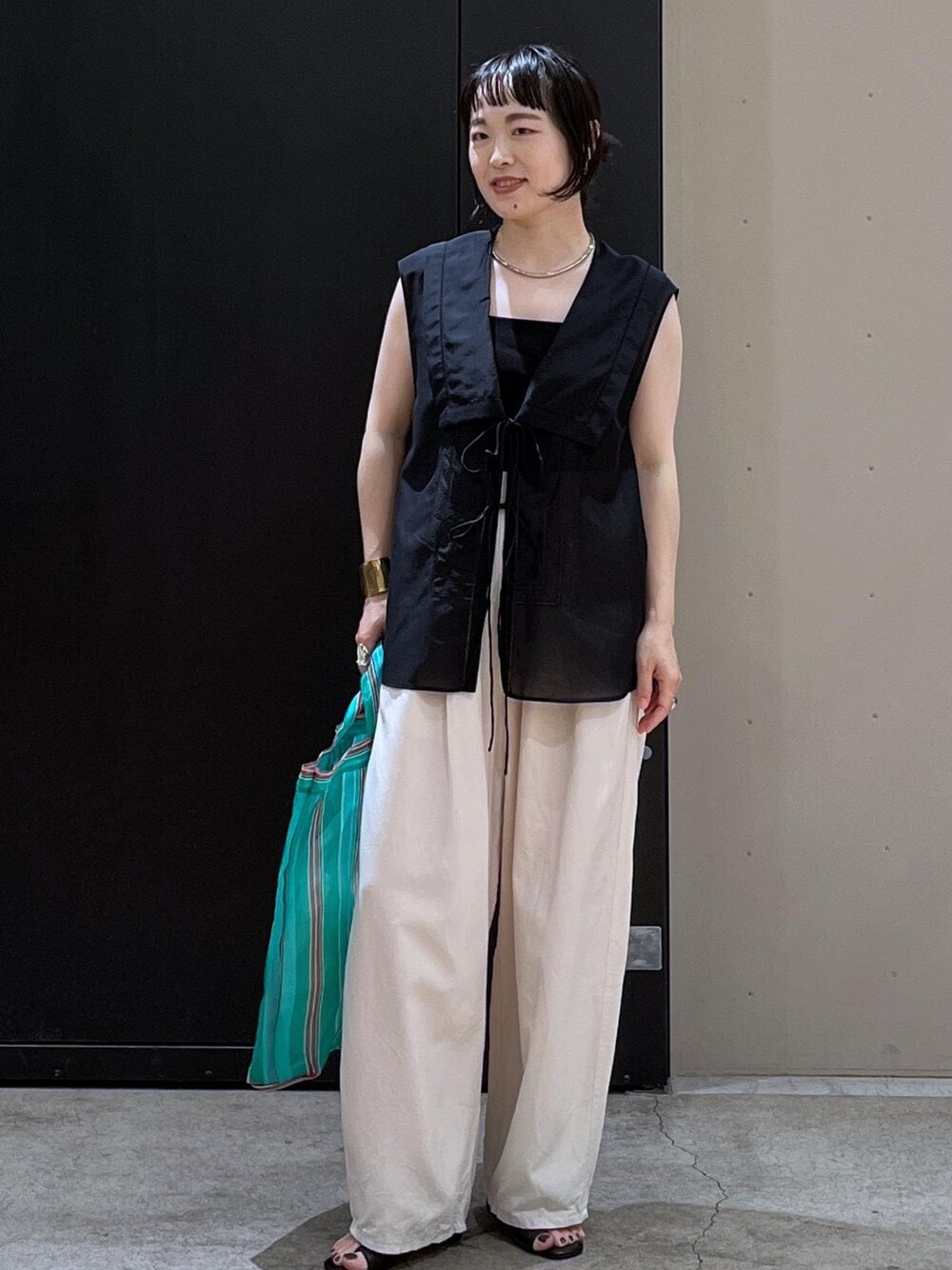 ホワイト系のその他パンツ、ブラック系のキャミソール、ブラック系のサンダルを着用したレディースの夏コーディネートの1枚目の写真