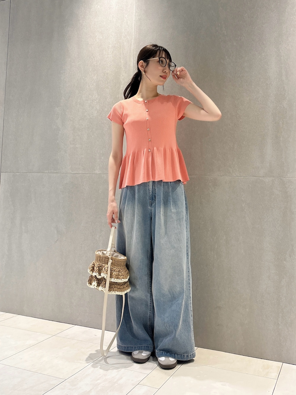 ピンク系のニット/セーター、ブルー系のその他パンツ、ベージュ系のショルダーバッグを着用したレディースの春コーディネートの1枚目の写真